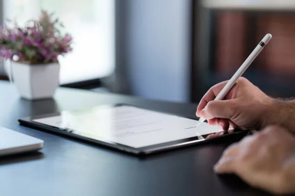 Businessman Signing Digital Contract On Tablet
